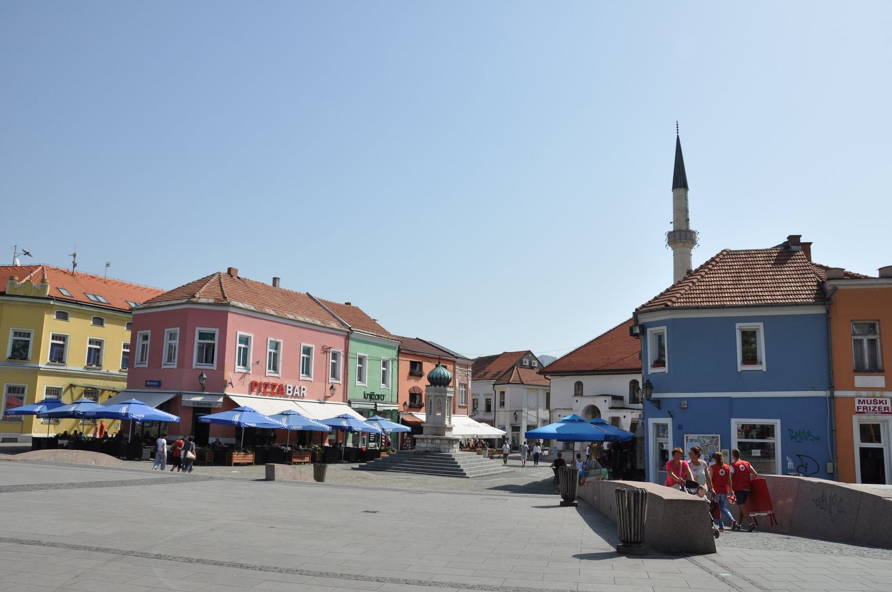 Freedom Square in Tuzla in summer, the mosque's minaret above the colourful houses