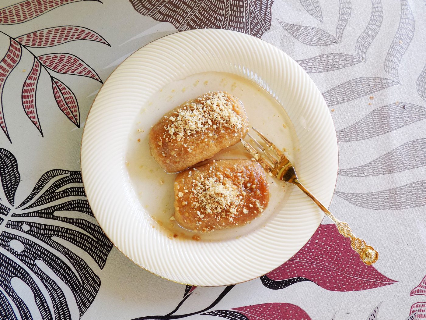 Two syrup-soaked hurmašice cakes on a plate
