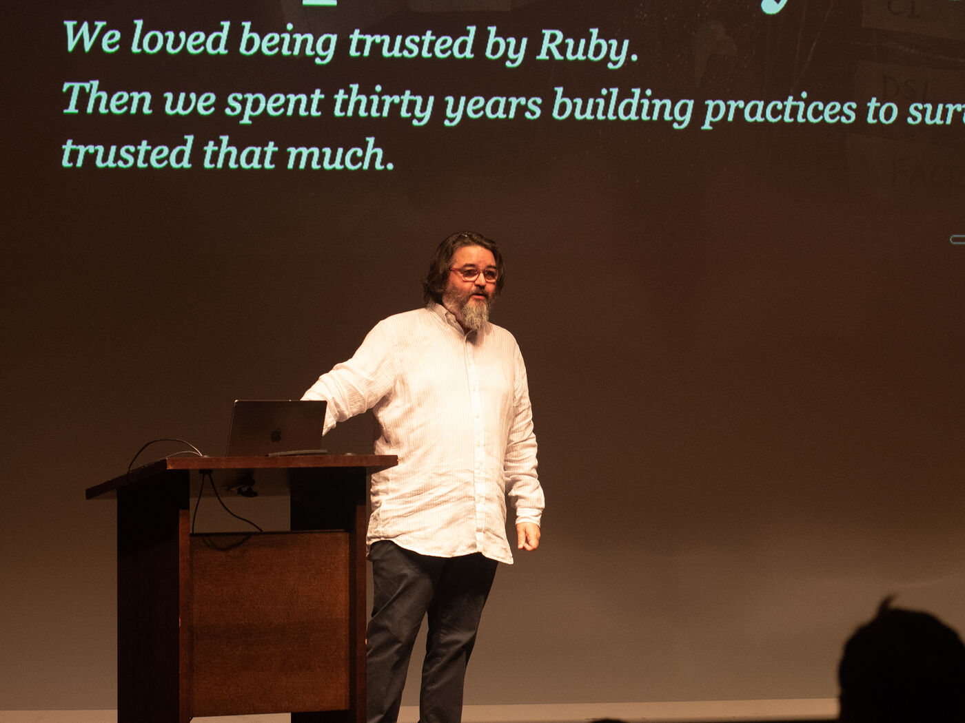 Chad Fowler at the lectern under a slide about being trusted by Ruby